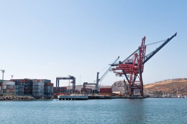 ENSENADA, MEXICO - MAY 3, 2017:  Ensenada International Terminal, the second busiest port in Mexico, with one super post-Panamax crane, two Panamax cranes, and one mobile crane. clipart