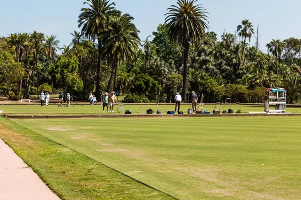 SAN DIEGO, CALIFORNIA - APRIL 28, 2017:  Teams of people playing lawn bowling in Balboa Park, which has the only grass rinks in the city.  The San Diego Lawn Bowling Club was established in 1932.