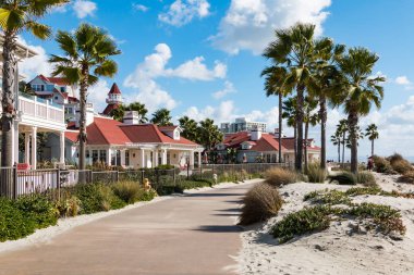 Coronado, California - 20 Ocak 2018: Plaj ve tarihi Hotel Del Coronado, 1888 yılında inşa edilmiş bir dönüm noktası San Diego bölgesinde plaj köy evler arasında bir tahta geçer.