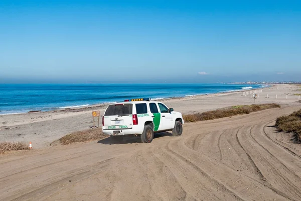 SAN DIEGO, CALIFORNIA - NOVEMBER 4, 2017:  A Border Patrol vehicle patrols Border Field State Park, the southwesternmost beach in the USA, and just across the border wall from Tijuana, Mexico.