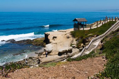 LA JOLLA, CALIFORNIA - JUNE 16, 2017:   A staircase leads down to Shell Beach, a popular place for beachcombing at La Jolla Shores Park in San Diego County.