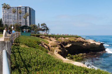 LA JOLLA, CALIFORNIA - JUNE 16, 2017:  People enjoy the beautiful ocean views near a hotel from the Rocky Point area pathway at La Jolla Cove. 