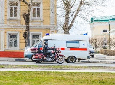 Kolomna sokakta Motosikletçi ve ambulans araba Ekim devrimi
