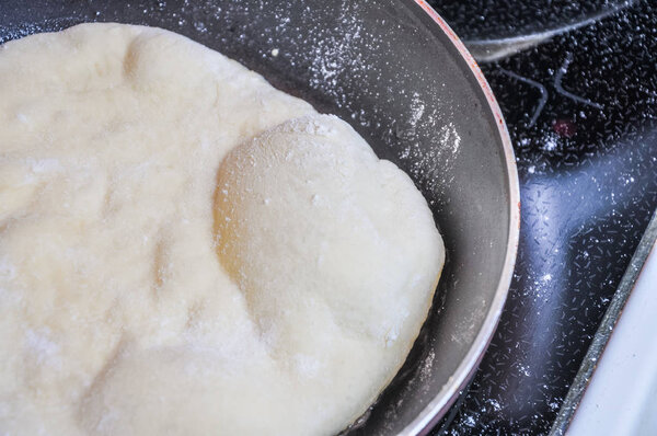 The process of making wheat tortillas in a pan on the stove