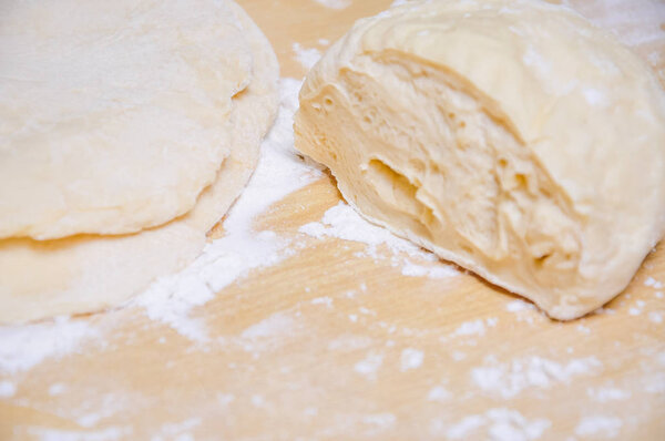 Raw wheat yeast dough on the table 