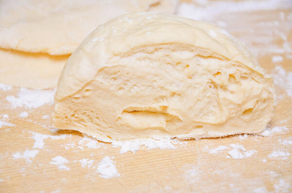 Raw wheat yeast dough on the table 