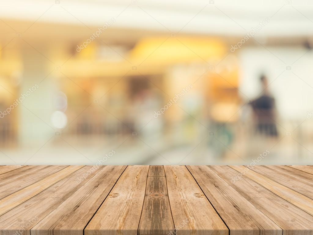 Wooden board empty table blurred background. Perspective brown wood over blur in department store - can be used for display or montage your products.Mock up for display of product.