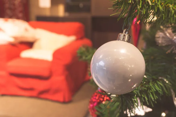 Κινηματογράφηση σε πρώτο πλάνο από λευκό μπιχλιμπίδι που κρέμονται από ένα στολισμένο χριστουγεννιάτικο δέντρο. — Φωτογραφία Αρχείου
