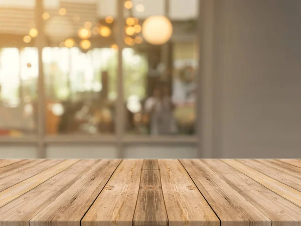 Tablero de madera mesa vacía sobre fondo borroso. Mesa de madera marrón perspectiva sobre desenfoque en el fondo de la cafetería - se puede utilizar la maqueta para la exhibición de productos de montaje o diseño diseño diseño visual clave. —  Fotos de Stock