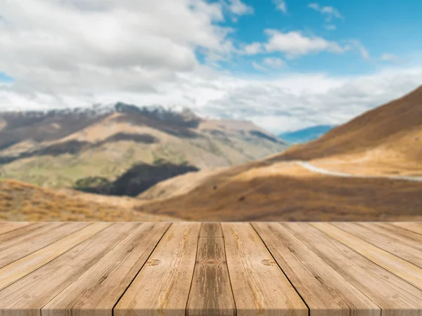 Holzbrett leerer Tisch vor verschwommenem Hintergrund. Perspektive braun Holztisch über verschwommener Berglandschaft Hintergrund - kann zur Anzeige oder Montage Ihrer Produkte verwendet werden. — Stockfoto