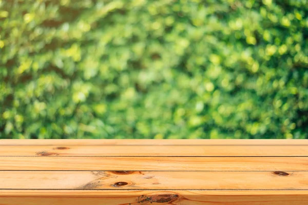 Wooden board empty table in front of blurred background. Perspective brown wood table over blur trees in forest background - can be used mock up for display or montage your products. spring season.