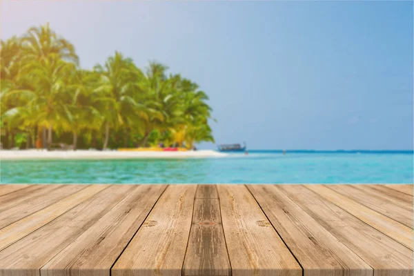 Holzbrett leeren Tisch vor blauem Meer & Himmel Hintergrund. Perspektivischer Holzboden über Meer und Himmel - kann zur Anzeige oder Montage Ihrer Produkte verwendet werden. Strand- & Sommerkonzepte. — Stockfoto