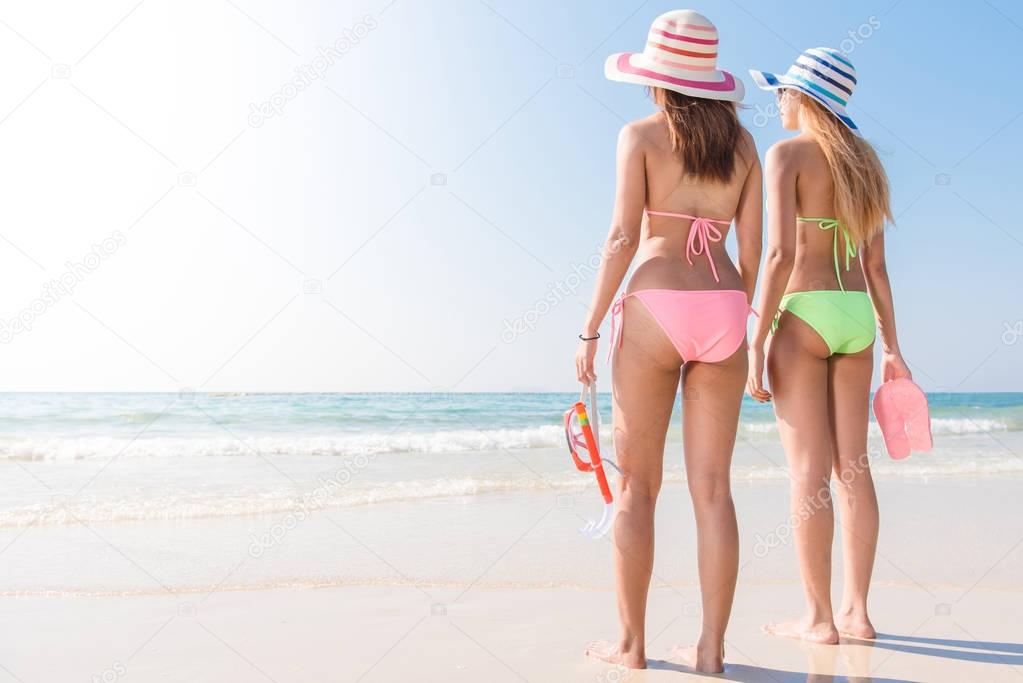 Beach vacation snorkel girl snorkeling with mask and fins. Bikini women relaxing on summer tropical getaway doing snorkeling activity with snorkel tuba and flippers sun tanning. Suntan skin body care.
