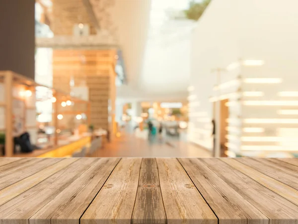 Wooden board empty table top on of blurred background. Perspective brown wood table over blur in coffee shop background - can be used mock up for montage products display or design key visual layout. — Stock Photo, Image