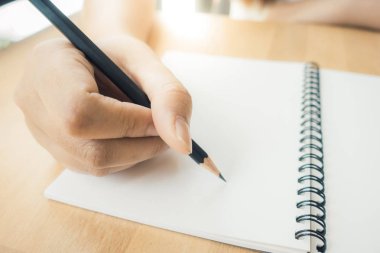 Kadın el yazma ofiste yaptırın. Ahşap masa üzerinde çalışan iş kadın. Dizüstü bilgisayar ve ofis çalışma iş kadını en iyi görünümü sağlar. Uzay kopyalayın. Vintage etkisi tarzı resimler.