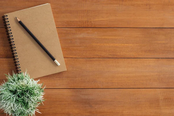 Minimal work space - Creative flat lay photo of workspace desk. Office desk wooden table background with mock up notebooks and pencil and plant. Top view with copy space, flat lay photography.