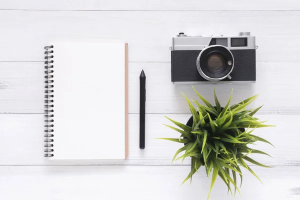 Minimal work space - Creative flat lay photo of workspace desk. White office desk wooden table background with mock up notebooks and retro camera. Top view with copy space, flat lay photography