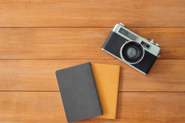 Minimal work space - Creative flat lay photo of workspace desk. Office desk wooden table background with mock up notebooks and retro camera. Top view with copy space, flat lay photography