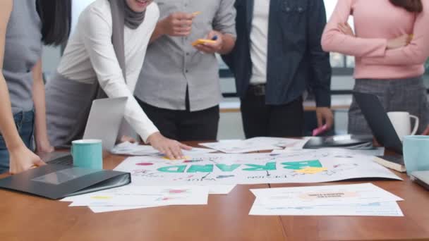 Nahaufnahme glücklicher junger asiatischer Geschäftsleute, die Brainstorming-Ideen über neue Papierkram-Projektkollegen treffen, die gemeinsam Erfolgsstrategien planen, genießen Teamarbeit im Büro. Zeitlupe.