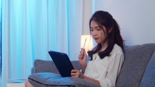 亚洲女商人在晚上从家里客厅工作时 用平板电脑和同事们谈论视频通话中的计划 自我隔离 社会疏离 检疫以预防结肠病毒 — 图库视频影像