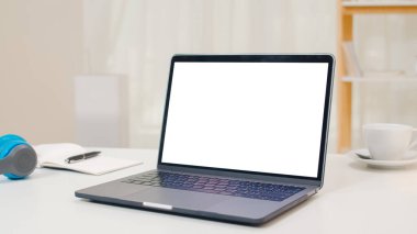 Modern evdeki rahat oturma odasındaki masanın üstünde duran beyaz ekran laptopunu taklit et..