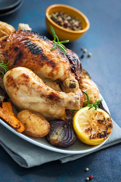 Homemade christmas chicken with vegetables on a plate, closeup