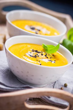 Homemade vegetable soup with pumpkin with cream and black sesame clipart