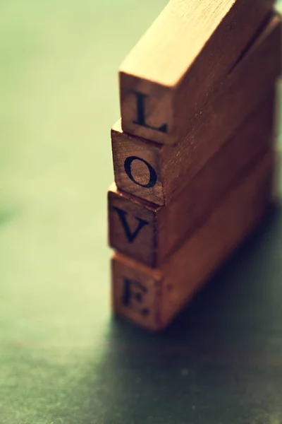 Love or Valentine 's Day Concept with Wooden Letters LOVE on a wo — стоковое фото