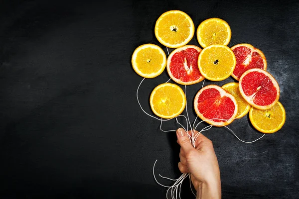 Food Art. Fruit slices on a dark Chalkboard Background with stri — Stock Photo, Image