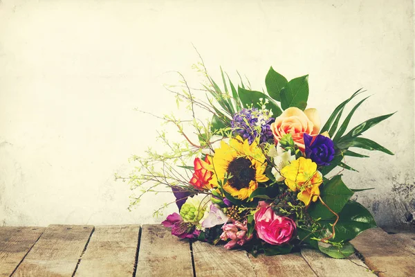 Beautiful bunch of flowers on wooden background. Horizontal.