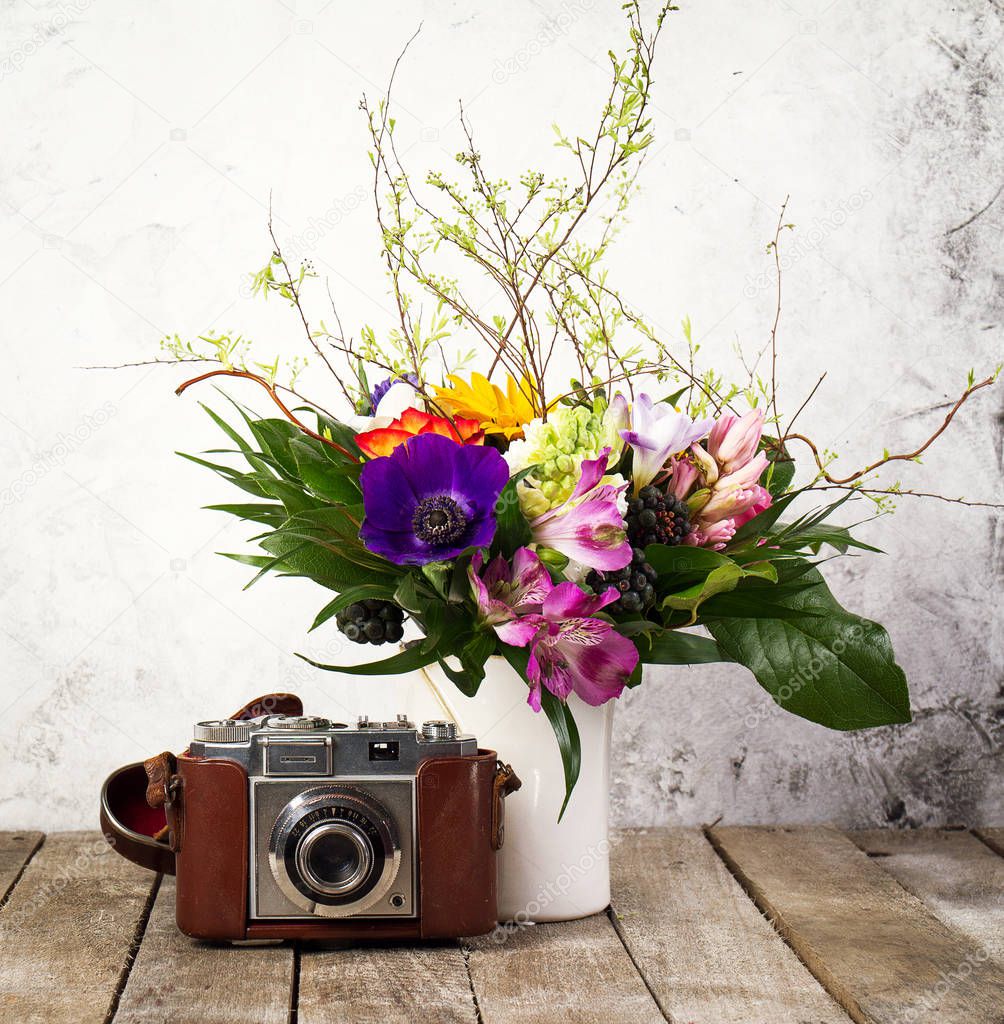 Old Vintage Camera with Beautiful Bouquet of Flowers