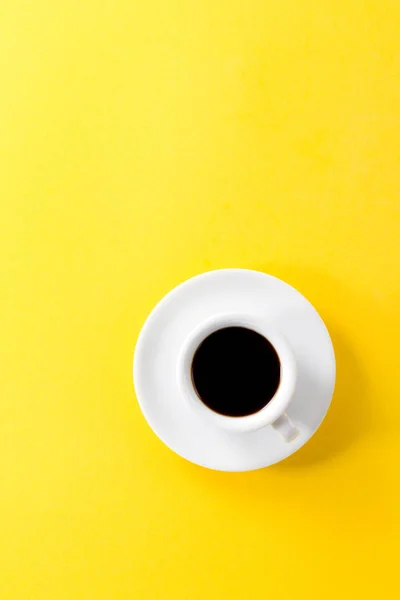Coffee espresso in small white ceramic cup on yellow vibrant — Stock Photo, Image