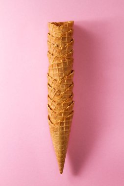 Lezzetli taze boş dondurma koni pembe canlı arka plan üzerinde. 
