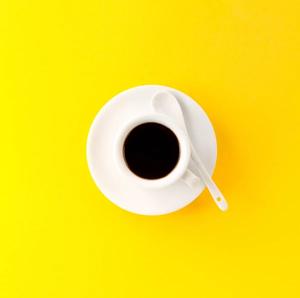 Coffee espresso in small white ceramic cup on yellow — Stock Photo, Image