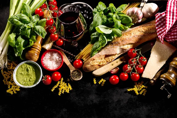 Tasty fresh appetizing italian food ingredients on dark background — Stock Photo, Image