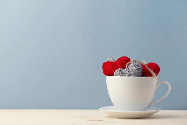 Knitted hearts in white cup — Stock Photo, Image