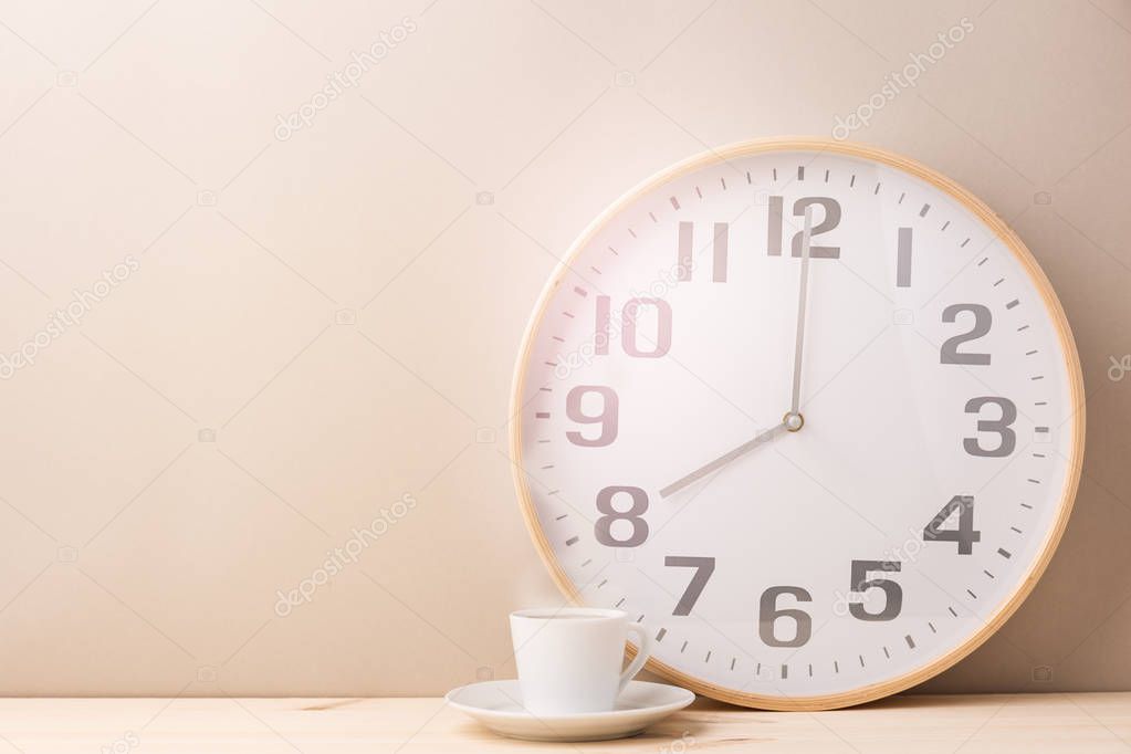 Steaming coffee cup and clock