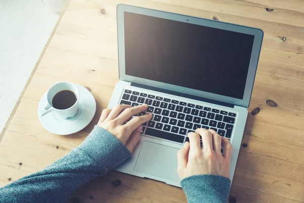 Unrecognizable person typing on laptop