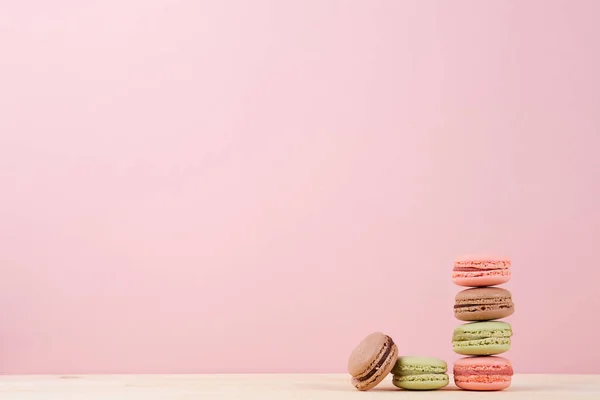 Stacked colorful macaroons on table — Stock Photo, Image