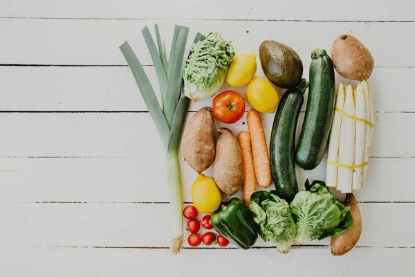 Assortment of vegetables on white wooden table — Stock Photo, Image