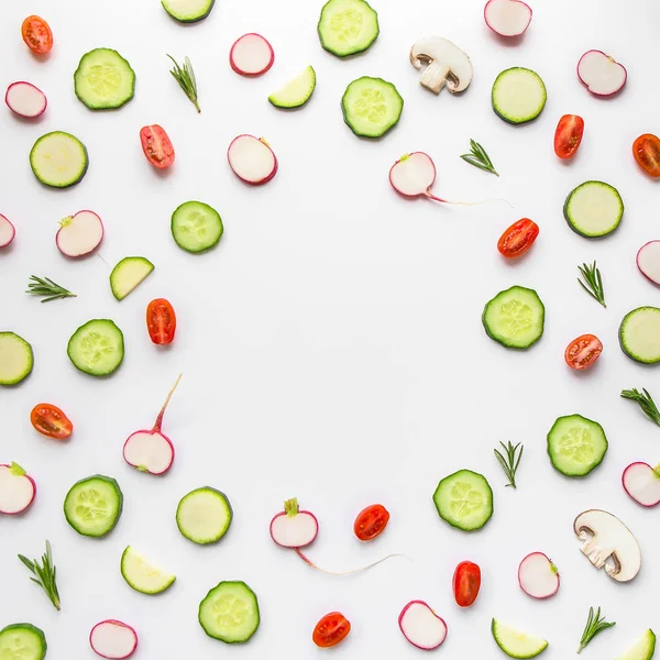 flay lay of various herb and vegetables slices in circle on white background