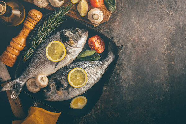 dorado with vegetables in baking pan 