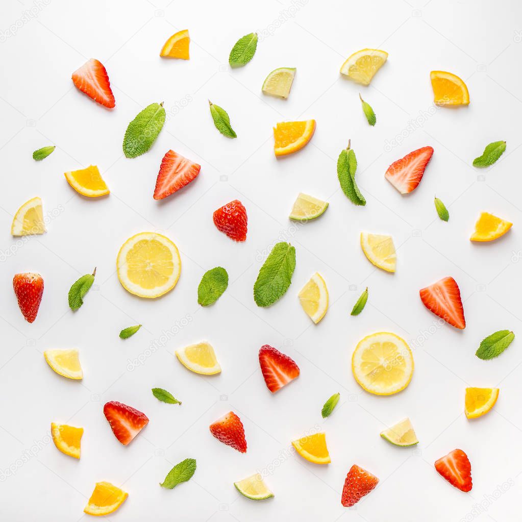 seamless background with slices of fresh citrus and strawberry in composition with banana and mint leaves