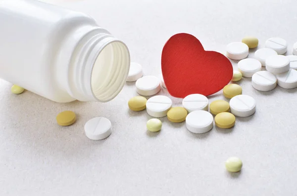 heart pills with empty plastic bottle