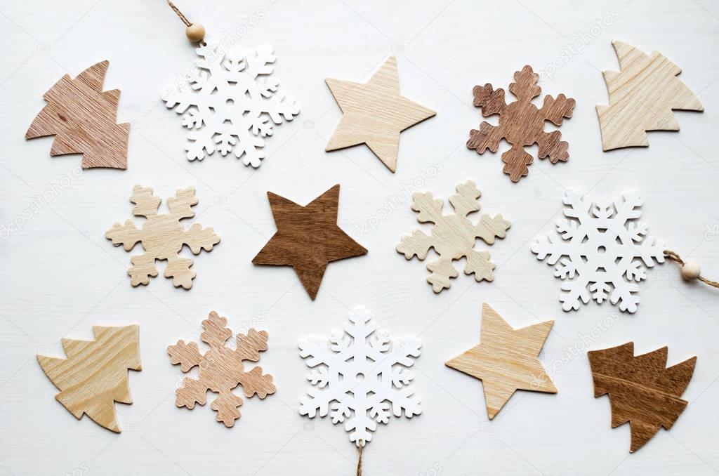 christmas frame composition with wooden snowflakes, stars and fir-trees