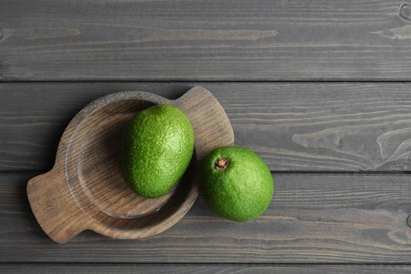 Aguacate orgánico fresco sobre fondo de mesa de madera oscura, vista superior, espacio para copiar — Foto de Stock