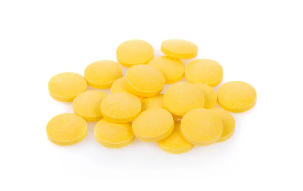 Pílulas amarelas isoladas no fundo branco — Fotografia de Stock