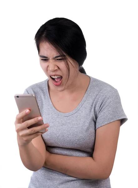 Angry woman using cellphone on white background — Stock Photo, Image