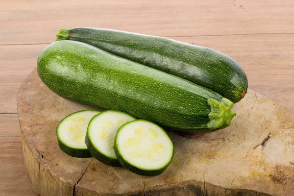 Green zucchini vegetables on wooden background — Stock Photo, Image