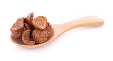 chocolate cereals in spoon on white background. Cornflakes